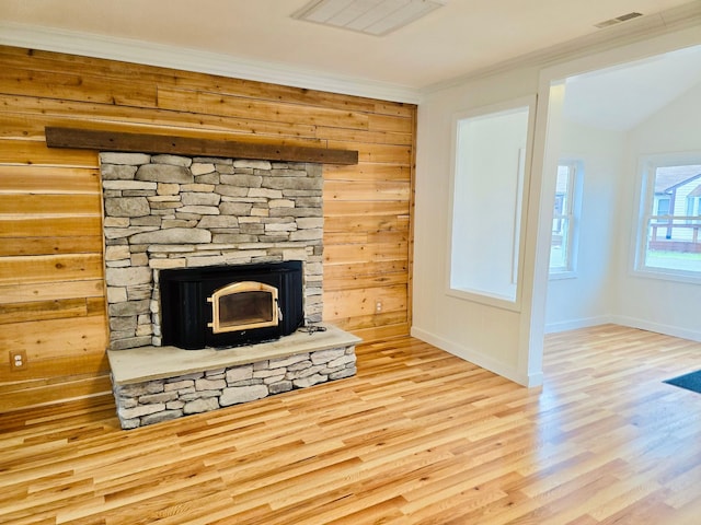 details featuring wood-type flooring, ornamental molding, a fireplace, and wooden walls