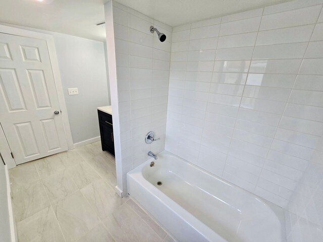 bathroom with vanity and tiled shower / bath combo