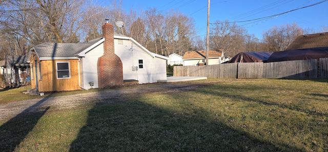 view of side of home with a lawn