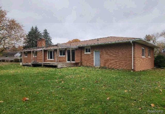 1080 Dye Krest Dr, Flint, MI 48532 - rear view of property featuring a yard, a chimney, and brick siding