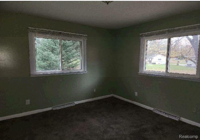 1080 Dye Krest Dr, Flint, MI 48532 - empty room with healthy amount of natural light and dark colored carpet