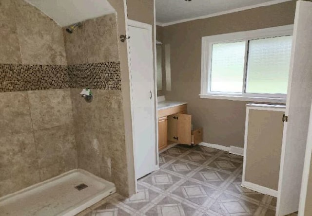 bathroom with a shower, crown molding, and vanity