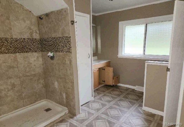 1080 Dye Krest Dr, Flint, MI 48532 - full bath featuring a tile shower, vanity, and ornamental molding