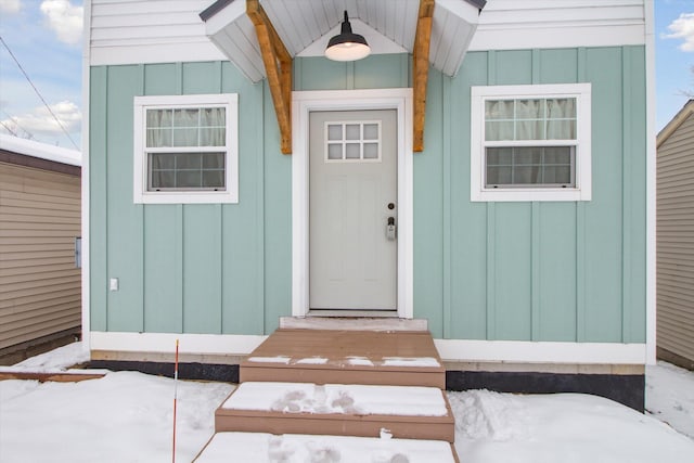 view of snow covered property entrance