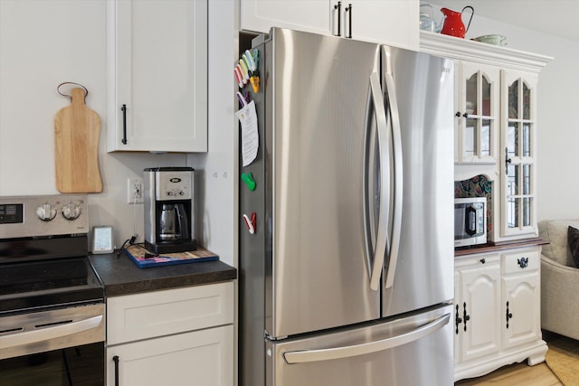 kitchen featuring white cabinetry and appliances with stainless steel finishes