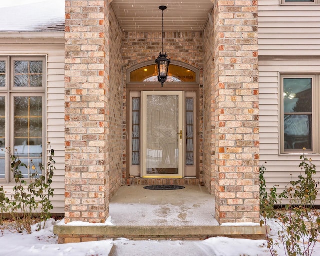 view of snow covered property entrance