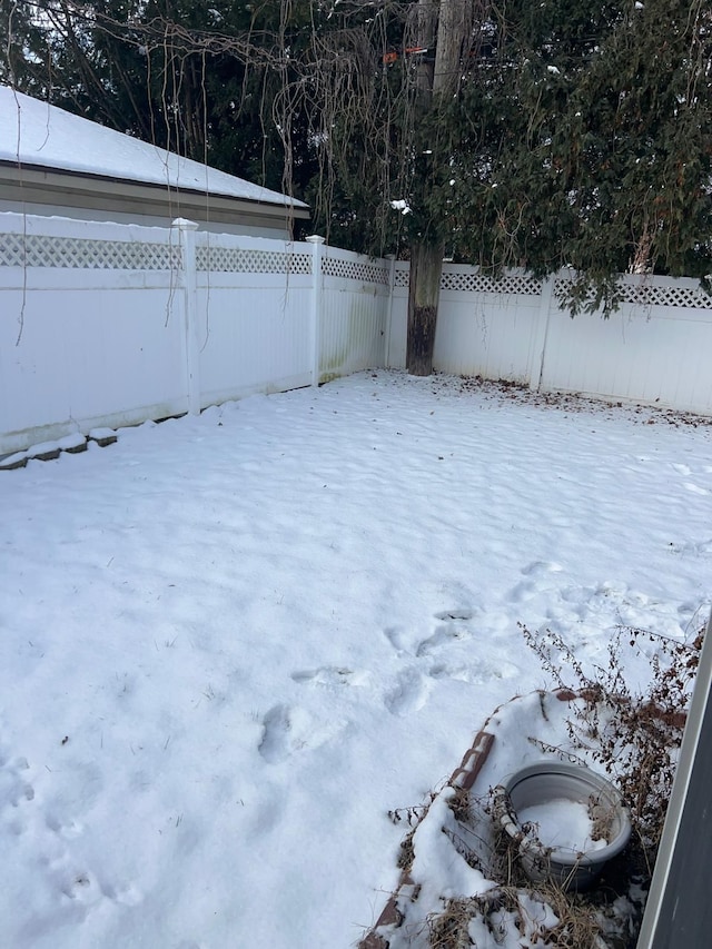 view of yard layered in snow