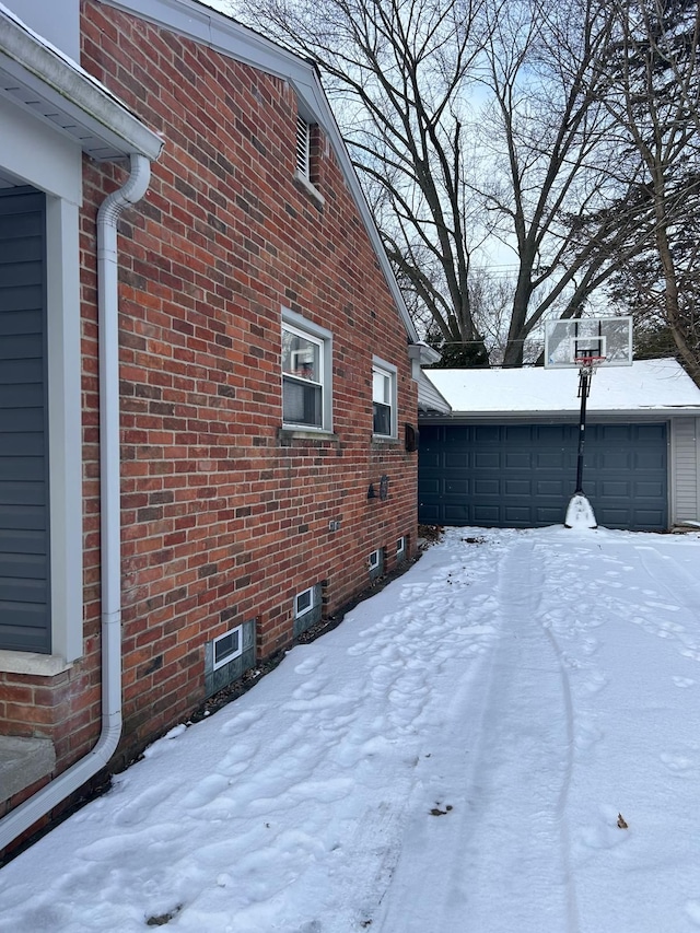 snow covered property featuring a garage