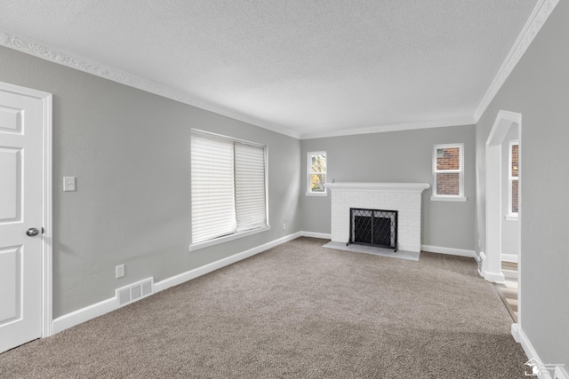 unfurnished living room with a fireplace, carpet flooring, and crown molding