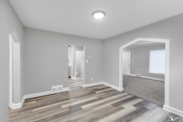 unfurnished room with wood-type flooring