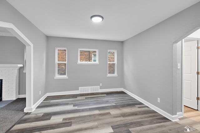 interior space with a fireplace and hardwood / wood-style floors