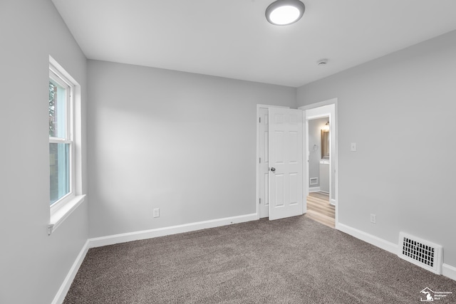 carpeted spare room with a healthy amount of sunlight