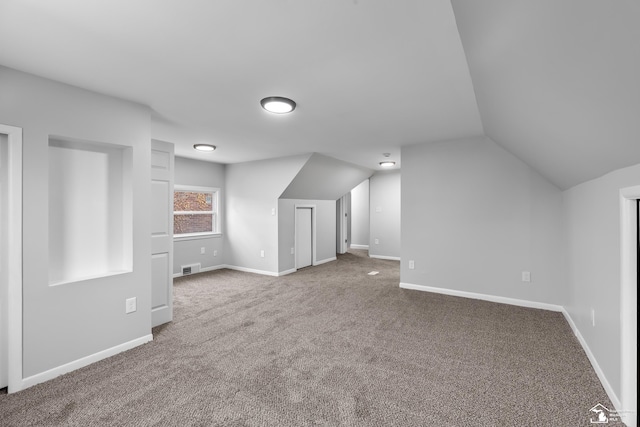 bonus room with carpet and vaulted ceiling