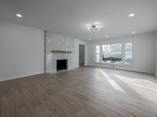 unfurnished living room featuring a fireplace and light wood-type flooring