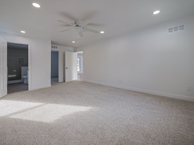 unfurnished bedroom featuring ensuite bath, carpet floors, and ceiling fan