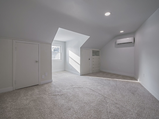 bonus room featuring lofted ceiling, light carpet, and a wall unit AC