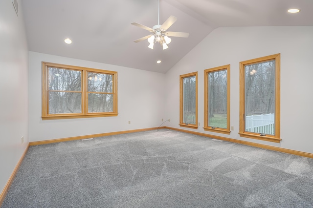 carpeted spare room with vaulted ceiling and ceiling fan