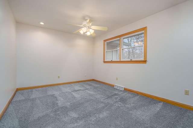 carpeted spare room featuring ceiling fan