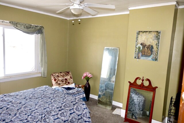 carpeted bedroom with ceiling fan and ornamental molding