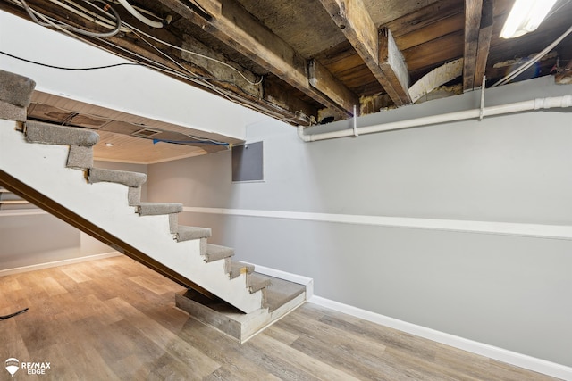 basement with light wood-type flooring and wooden ceiling