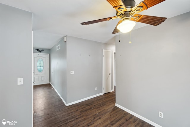 unfurnished room with ceiling fan and dark hardwood / wood-style flooring