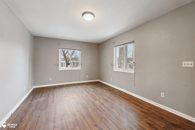 unfurnished room with dark hardwood / wood-style floors