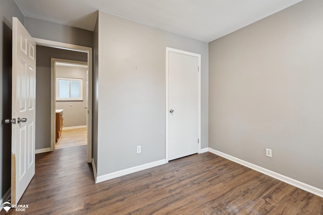 unfurnished bedroom with dark hardwood / wood-style floors