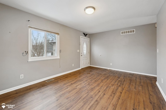 unfurnished room featuring dark hardwood / wood-style floors