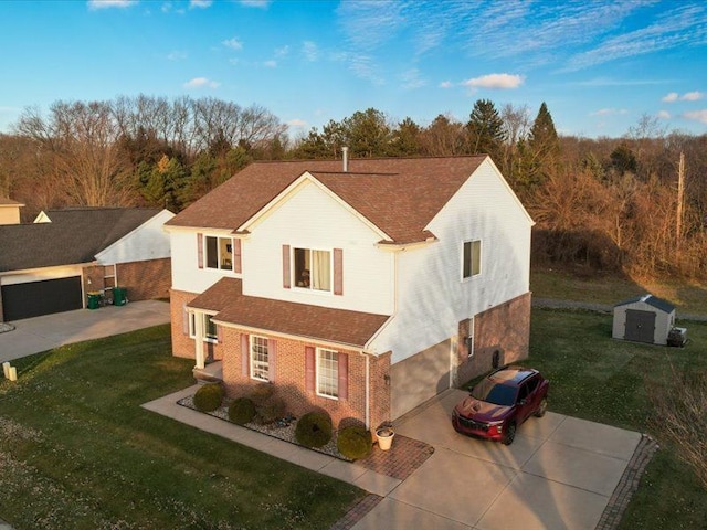 view of front of home with a front lawn, a garage, and a storage unit