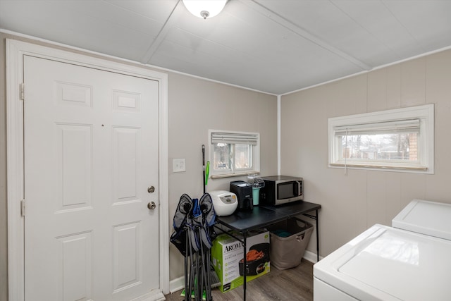 clothes washing area featuring washing machine and dryer and hardwood / wood-style floors