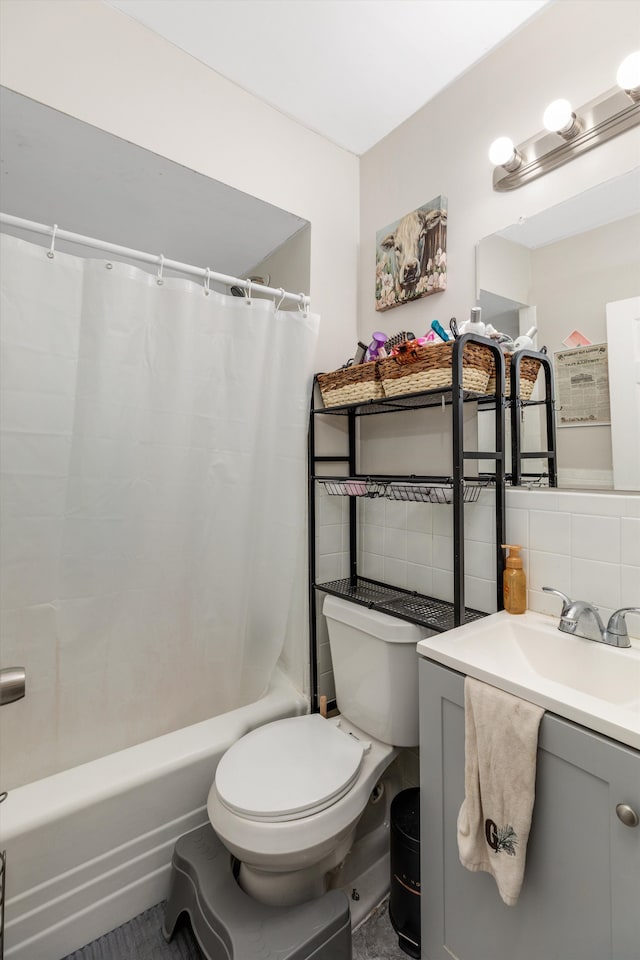 full bathroom featuring shower / bath combo, tasteful backsplash, vanity, tile walls, and toilet