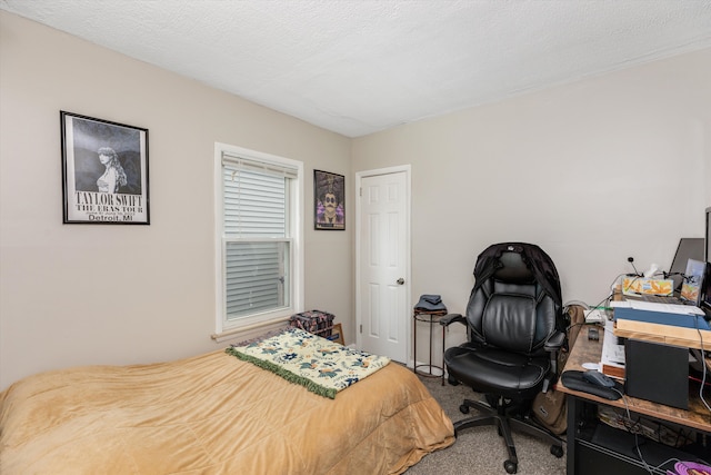 bedroom featuring carpet and a textured ceiling