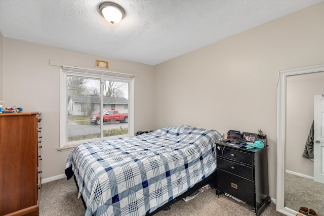 carpeted bedroom with a textured ceiling