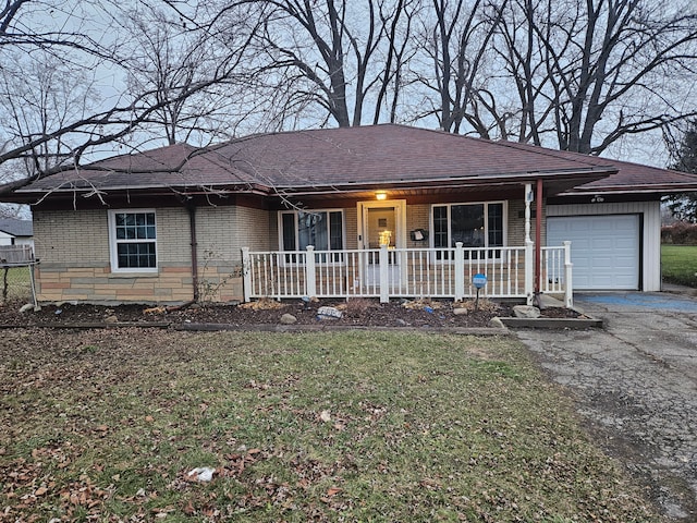 single story home featuring a front lawn and a garage