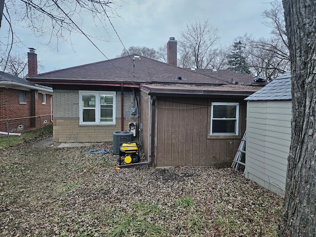 rear view of house with central air condition unit