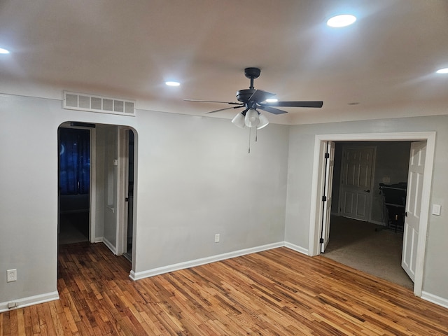 empty room with ceiling fan and dark wood-type flooring