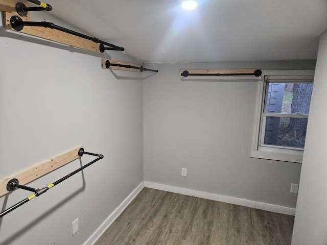 spacious closet with wood-type flooring and lofted ceiling