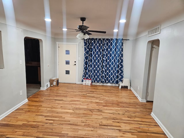 unfurnished living room featuring ceiling fan and light hardwood / wood-style floors