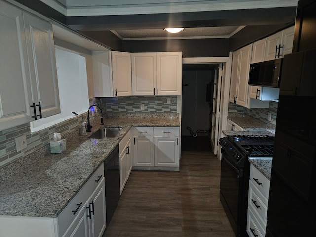 kitchen featuring light stone countertops, sink, tasteful backsplash, white cabinets, and black appliances