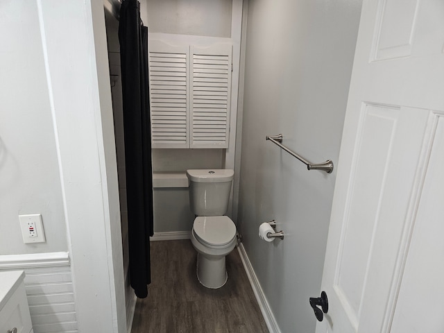 bathroom with hardwood / wood-style floors, vanity, and toilet