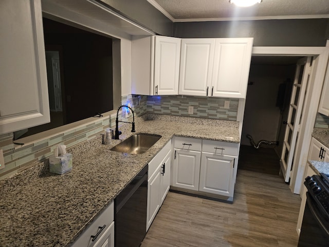 kitchen featuring white cabinets, sink, tasteful backsplash, and black appliances