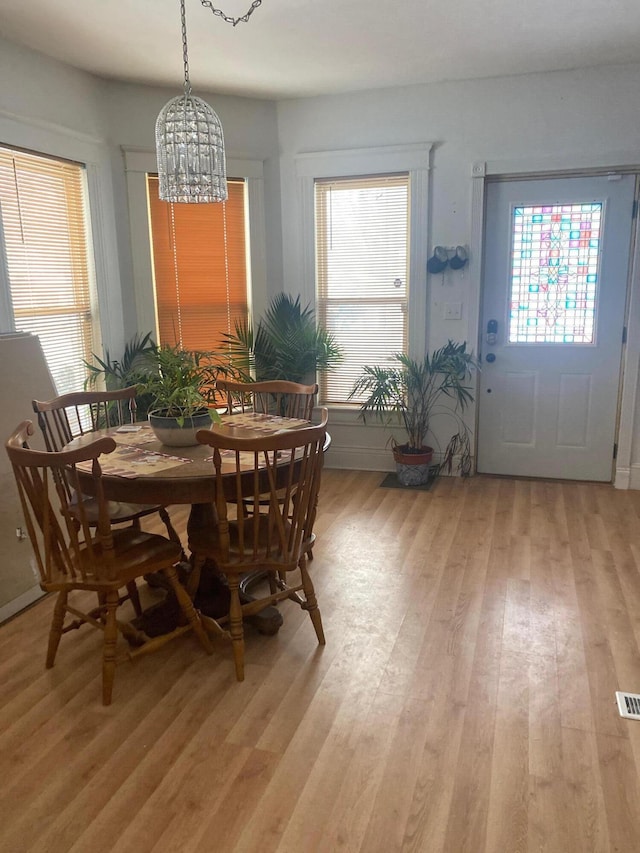 dining room featuring light hardwood / wood-style floors and a chandelier