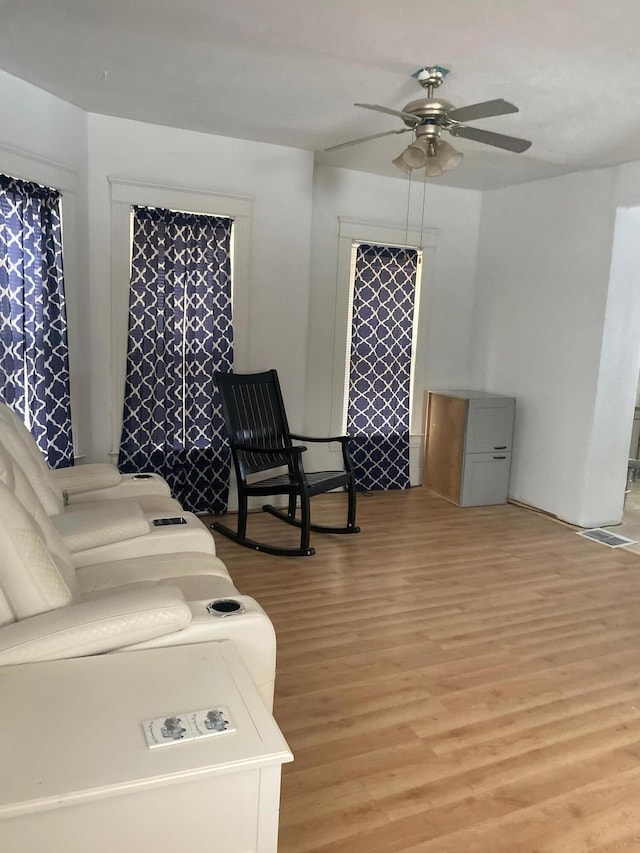 living room with ceiling fan and light wood-type flooring