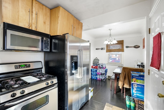 kitchen featuring pendant lighting, stainless steel appliances, and an inviting chandelier