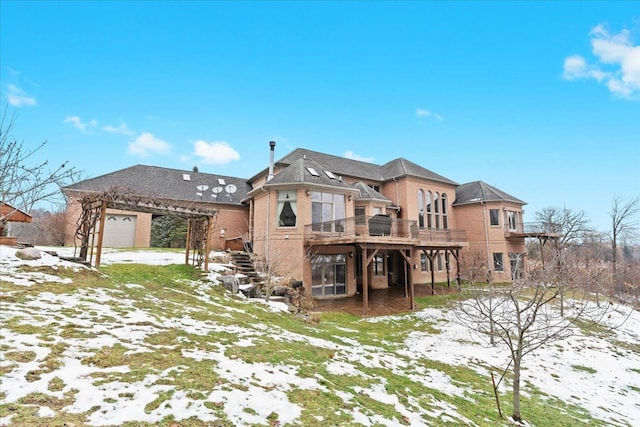 snow covered rear of property with a wooden deck