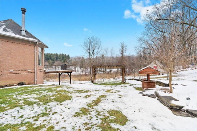 yard covered in snow featuring a wooden deck