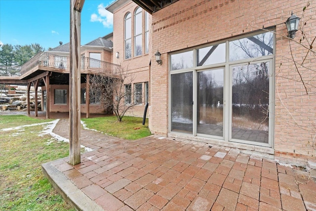 back of property with a deck and a patio area