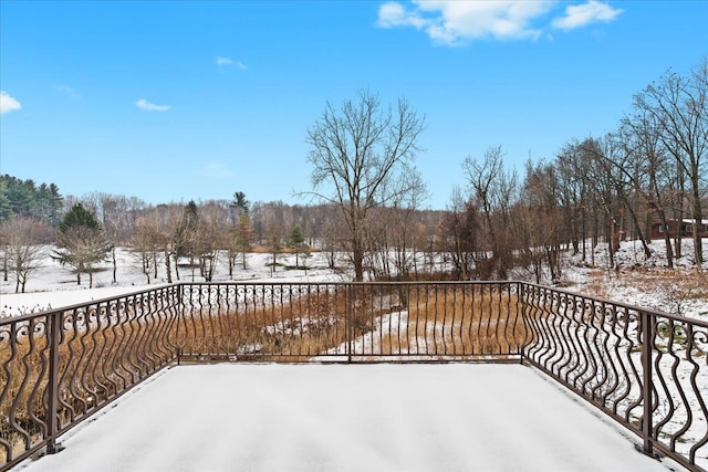 view of snow covered back of property