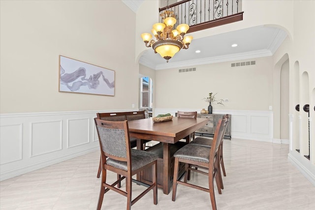 dining space featuring ornamental molding and a notable chandelier