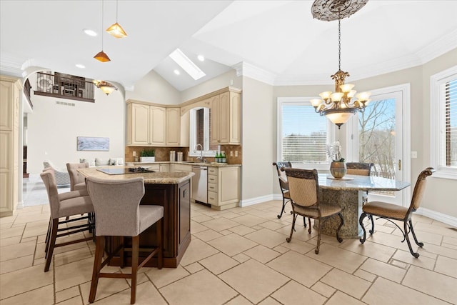 kitchen featuring light stone countertops, dishwasher, backsplash, lofted ceiling with skylight, and pendant lighting